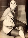 Smiling chick in stockings shows off her hairy pussy