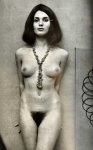 Erotic pictorial of standing nude model against wall