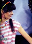 Girl in striped tee wears colorful beads